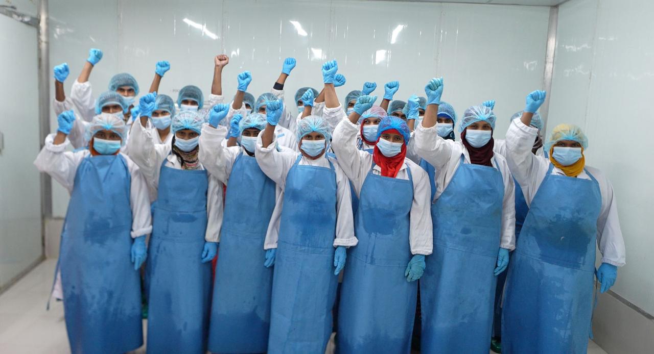 Export processing team in food safety PPE at the facility